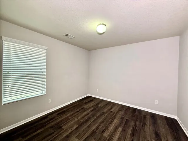 an empty room with wooden floor