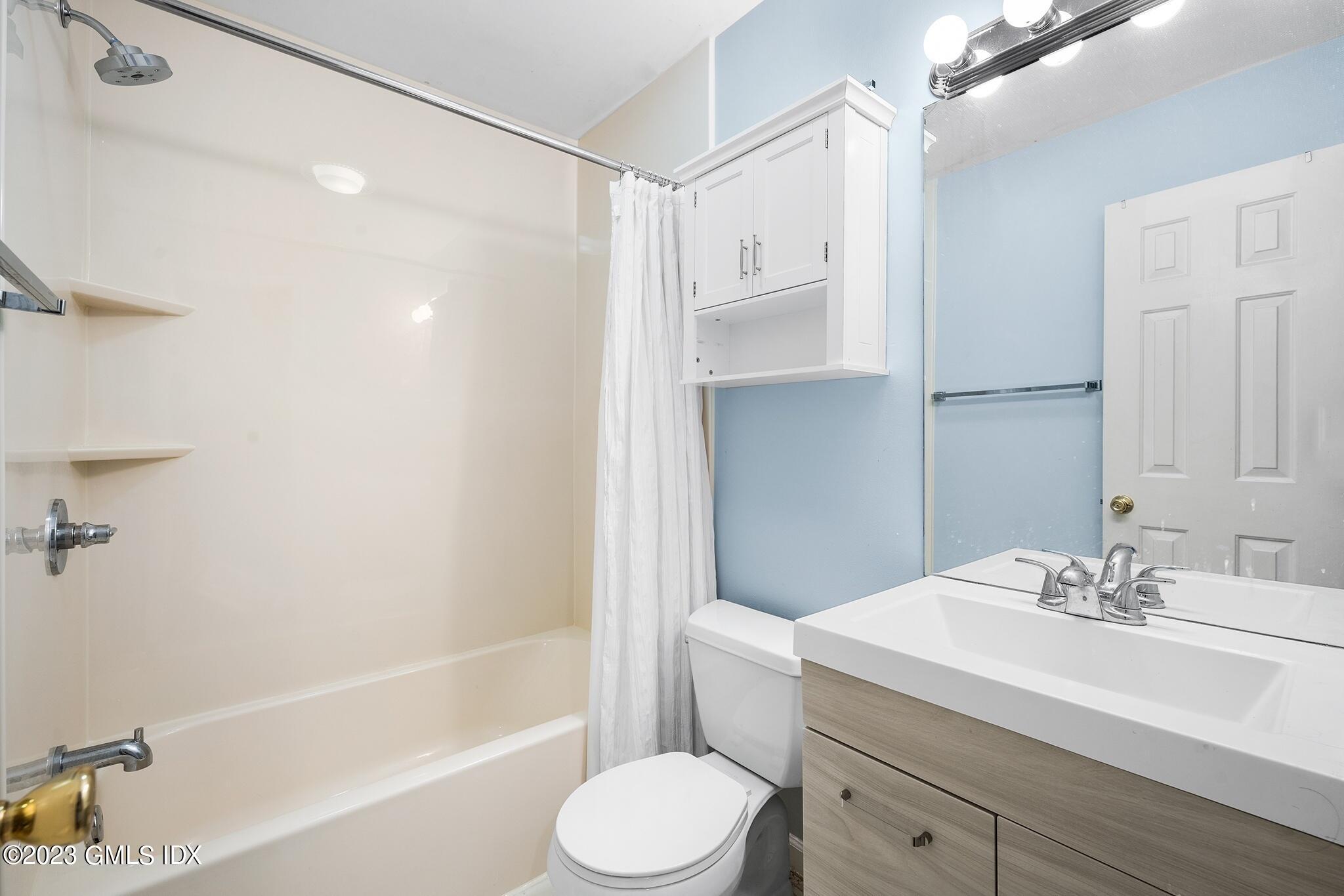 53 Bible Street, Unit 1 Cos Cob, CT 06807 - Photo 9 of 14 a bathroom with a sink toilet and shower