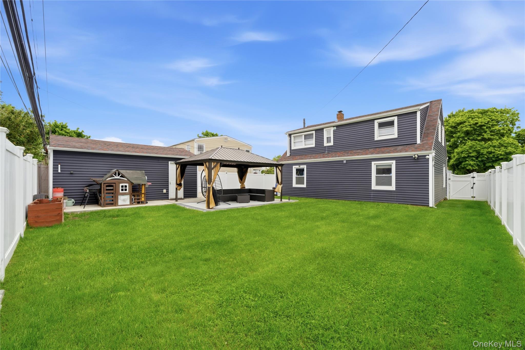 50 Ridge Lane Levittown, NY 11756 - Photo 23 of 27 a front view of a house with a garden