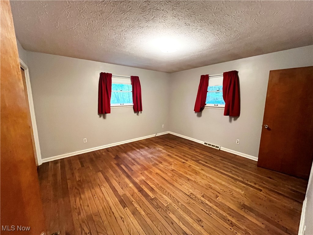 2300 River Road Willoughby, OH 44094 - Photo 19 of 28 Unfurnished bedroom with hardwood / wood-style flooring and a textured ceiling
