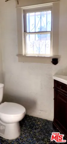 a bathroom with a toilet and a window