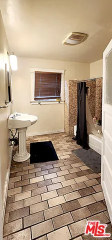 a living room with a rug and a table