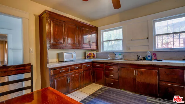a kitchen with stainless steel appliances granite countertop a sink dishwasher stove and cabinets with wooden floor