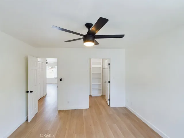 a view of an empty room and wooden floor
