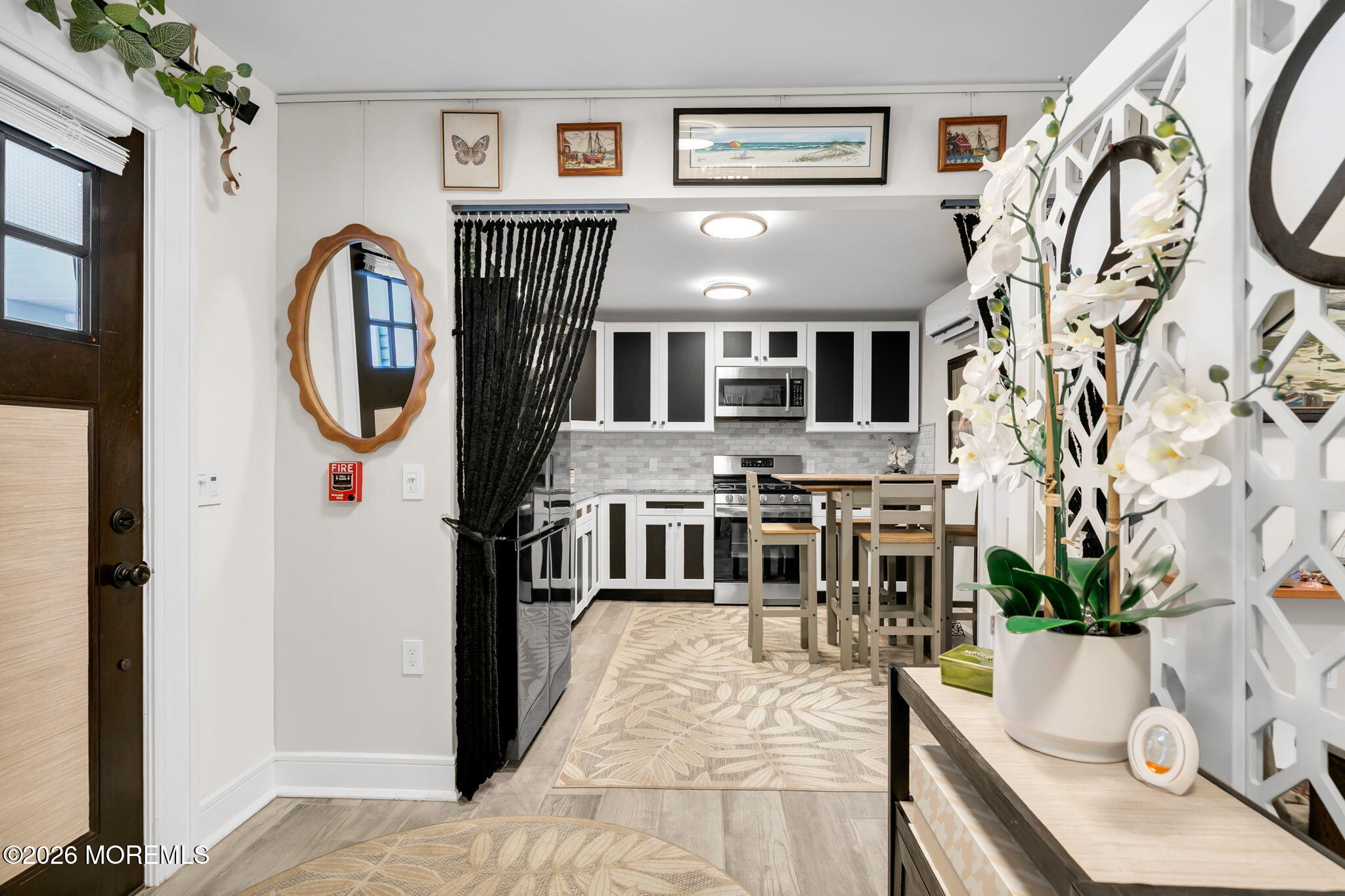 1301 Ocean Avenue, Unit 2 Point Pleasant Beach, NJ 08742 - Photo 14 of 31 a living room with furniture a flat screen tv and a fireplace