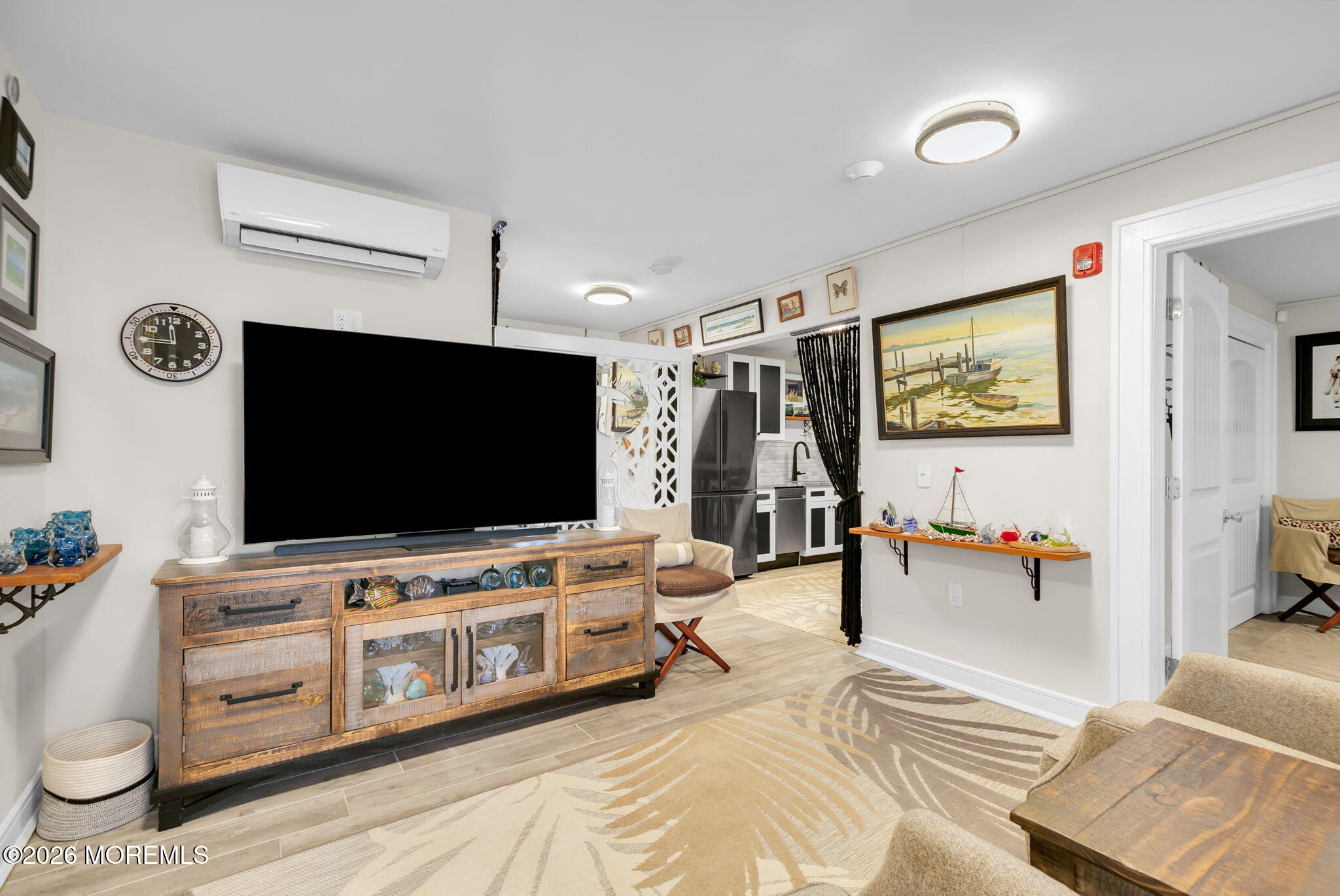 1301 Ocean Avenue, Unit 2 Point Pleasant Beach, NJ 08742 - Photo 16 of 31 a living room with furniture and a flat screen tv
