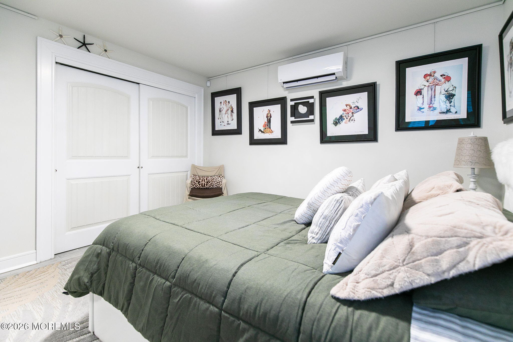 1301 Ocean Avenue, Unit 2 Point Pleasant Beach, NJ 08742 - Photo 17 of 31 a bedroom with a bed and a painting on the wall