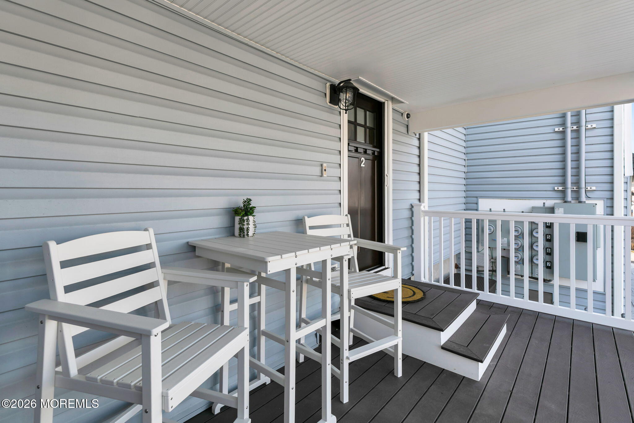 1301 Ocean Avenue, Unit 2 Point Pleasant Beach, NJ 08742 - Photo 24 of 31 a view of a patio with table and chairs with wooden floor and fence