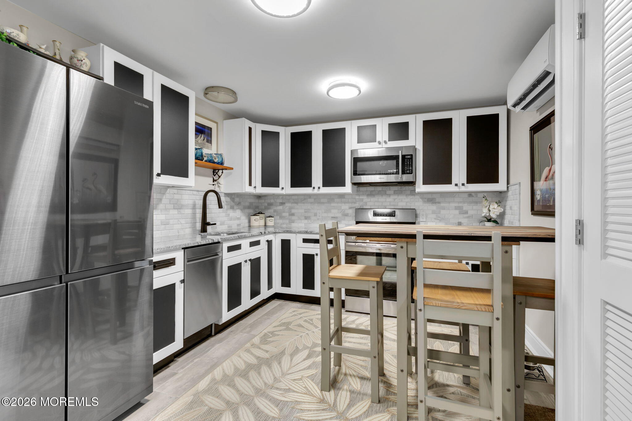 1301 Ocean Avenue, Unit 2 Point Pleasant Beach, NJ 08742 - Photo 9 of 31 a kitchen with stainless steel appliances granite countertop a stove top oven a refrigerator and a sink