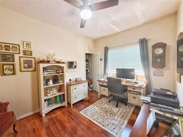 a view of a workspace with furniture and a window