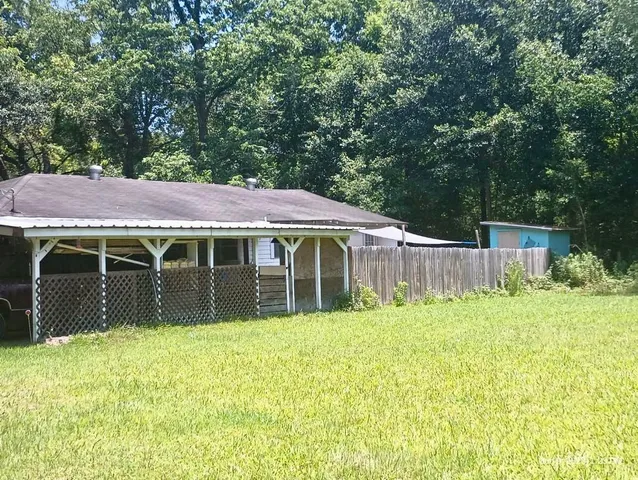 a view of a house with yard and sitting area