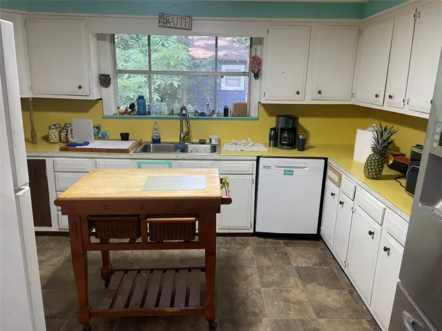 a kitchen with a sink cabinets and window
