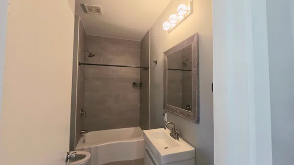 a bathroom with a bathtub and shower