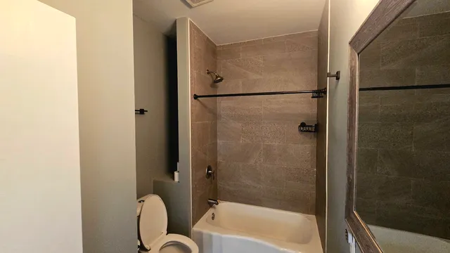 a bathroom with a tub and a shower