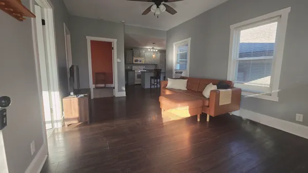 a living room with furniture window and wooden floor
