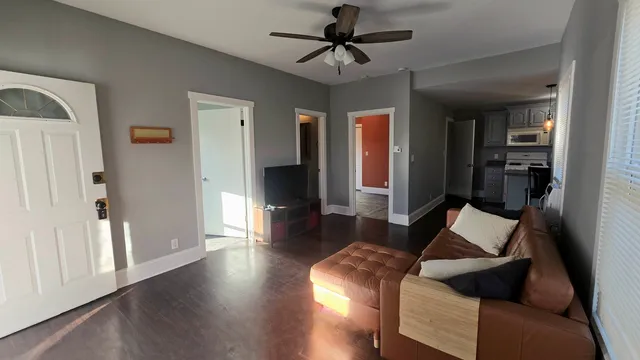 a living room with furniture and wooden floor