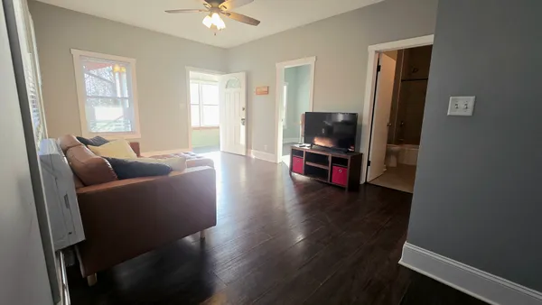 a living room with furniture and a flat screen tv