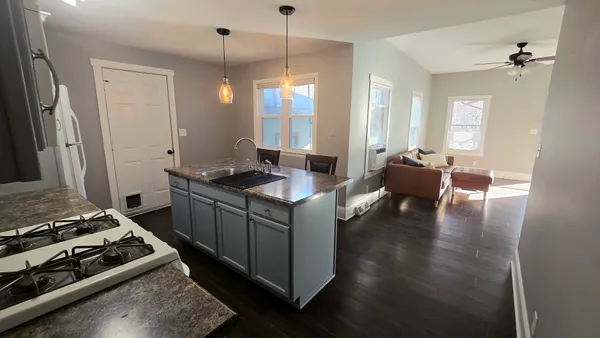 a kitchen with sink stove and refrigerator