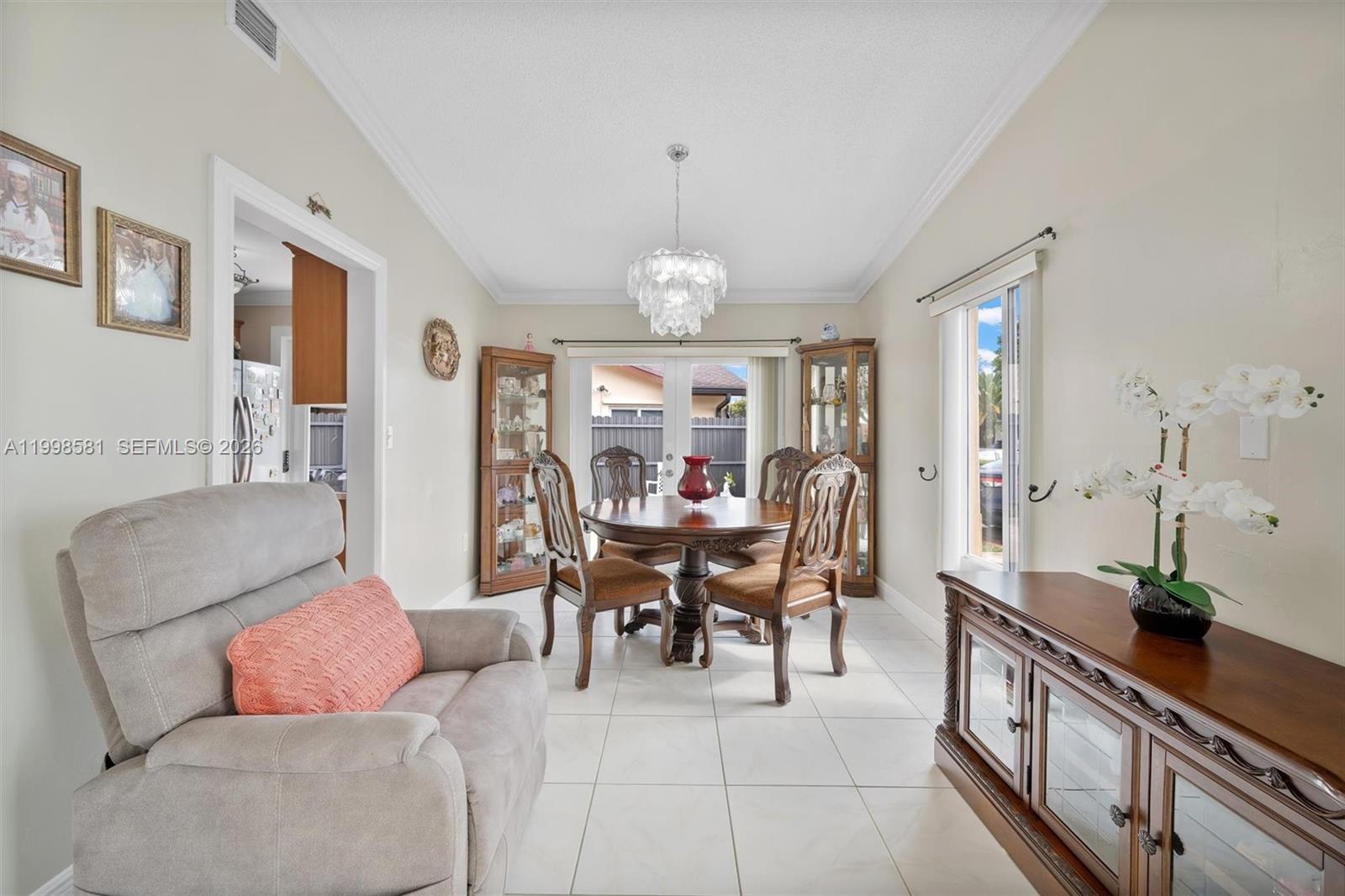 4218 Southwest 138th Court Miami, FL 33175 - Photo 12 of 24 a dining room with furniture a chandelier and wooden floor