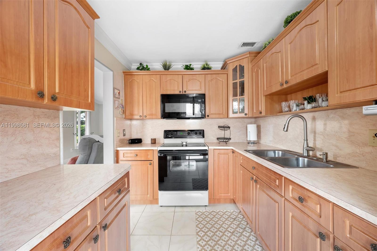 4218 Southwest 138th Court Miami, FL 33175 - Photo 13 of 24 a kitchen with stainless steel appliances granite countertop a sink and a stove