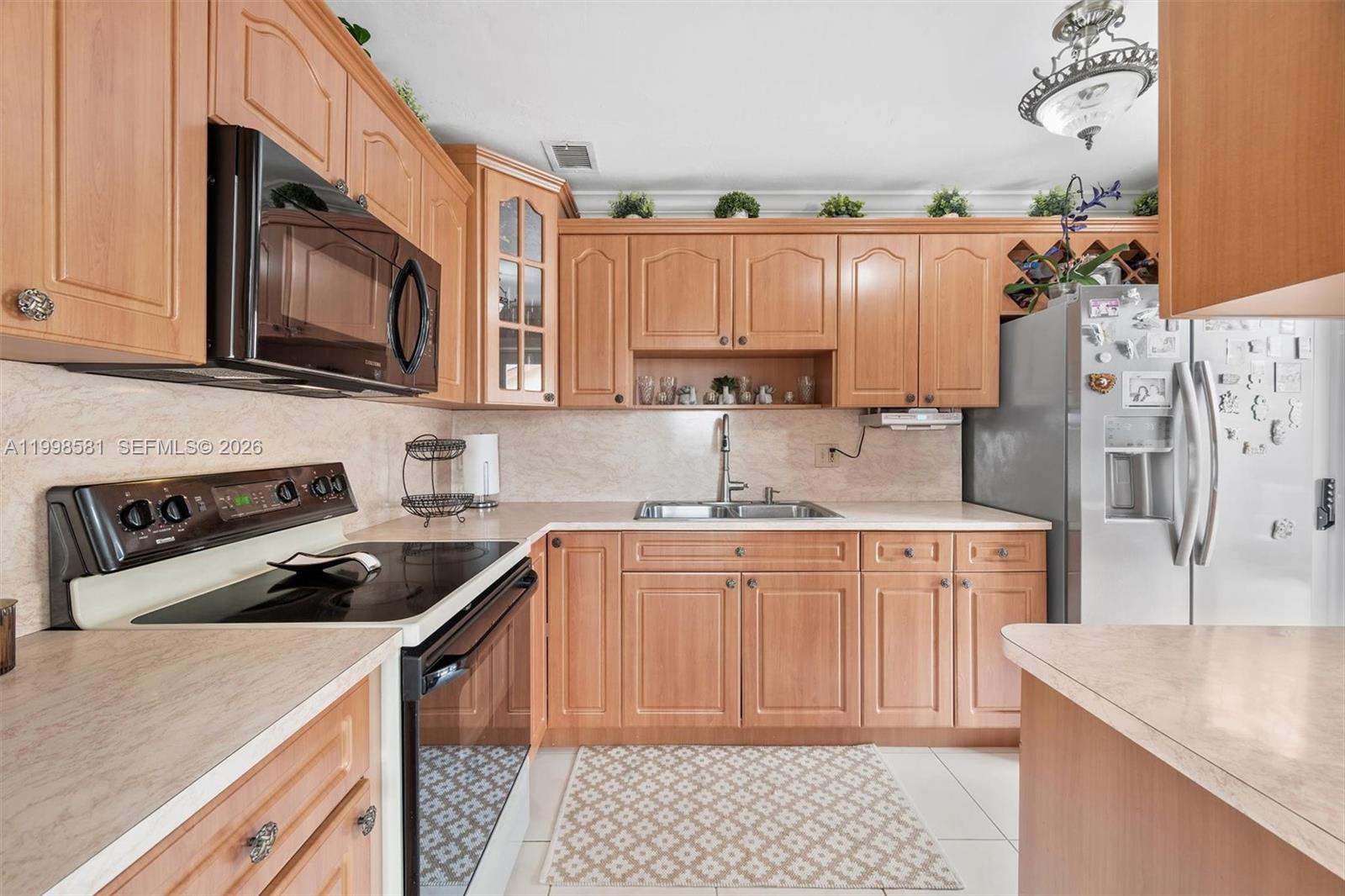 4218 Southwest 138th Court Miami, FL 33175 - Photo 14 of 24 a kitchen with stainless steel appliances granite countertop a sink stove and refrigerator