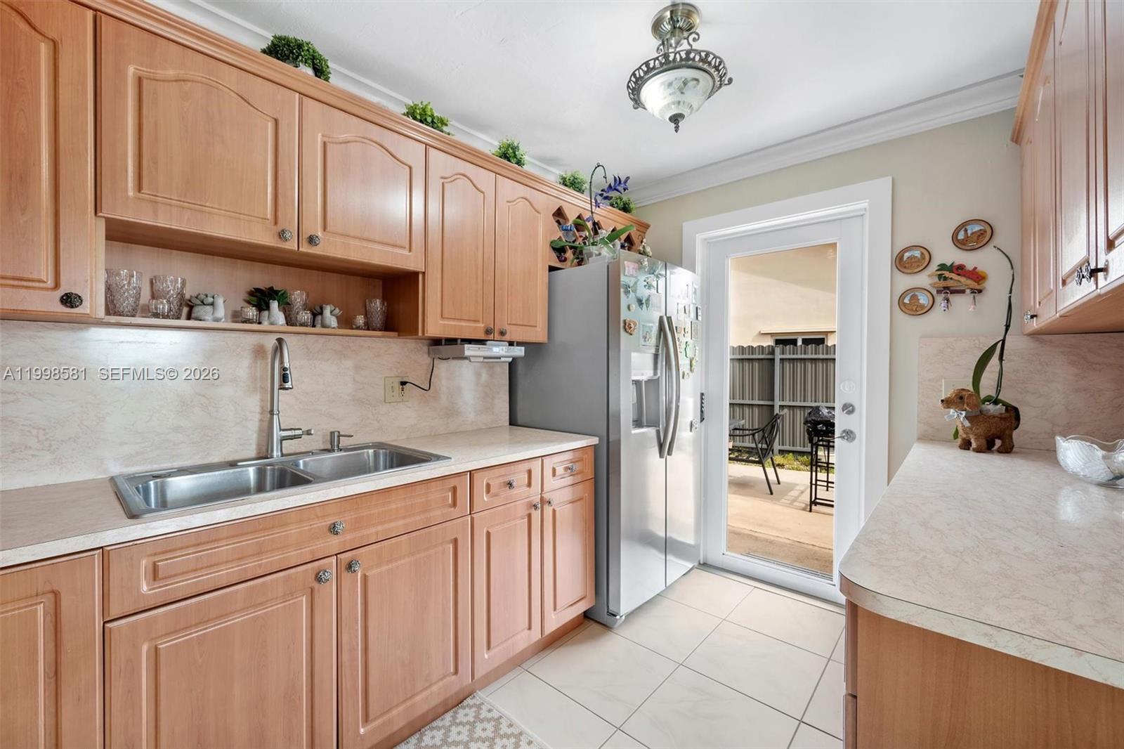 4218 Southwest 138th Court Miami, FL 33175 - Photo 15 of 24 a kitchen with stainless steel appliances granite countertop a sink stove and refrigerator