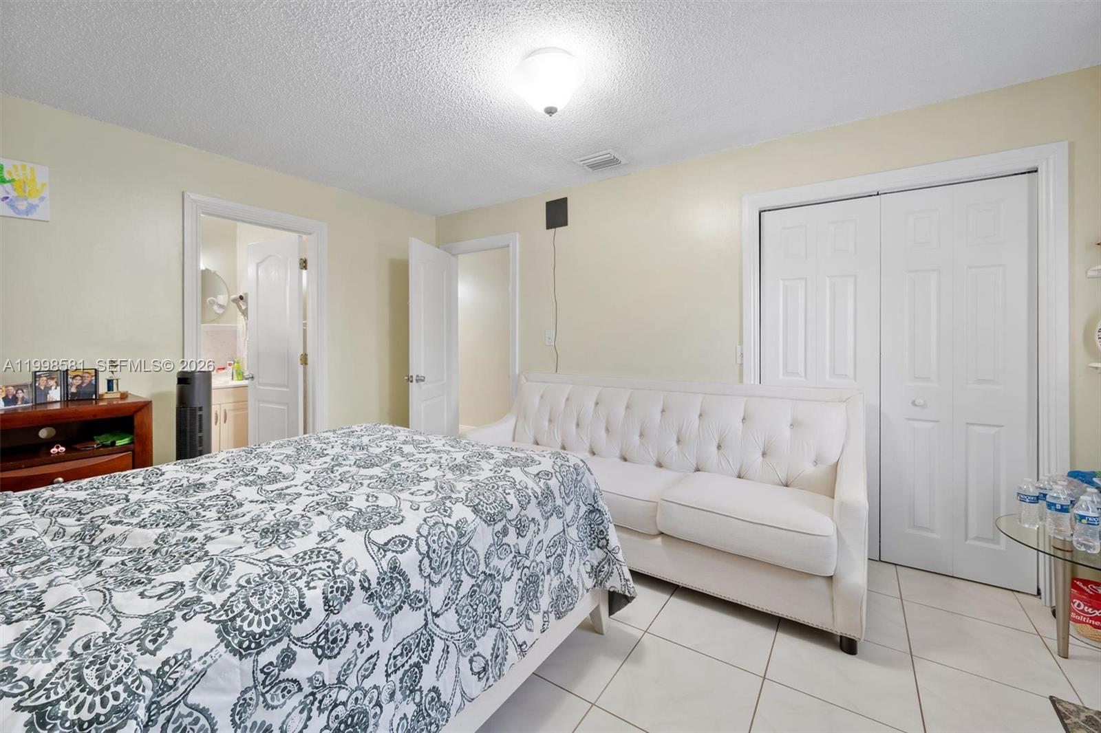 4218 Southwest 138th Court Miami, FL 33175 - Photo 17 of 24 a spacious bedroom with a bed and a couch