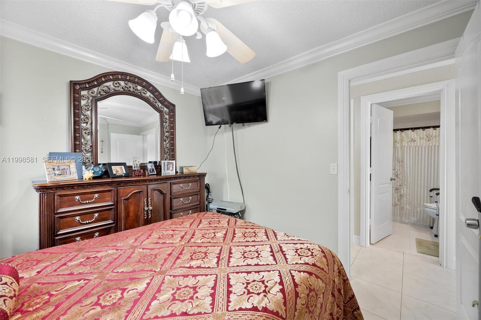 4218 Southwest 138th Court Miami, FL 33175 - Photo 23 of 24 a bedroom with a bed and a flat screen tv