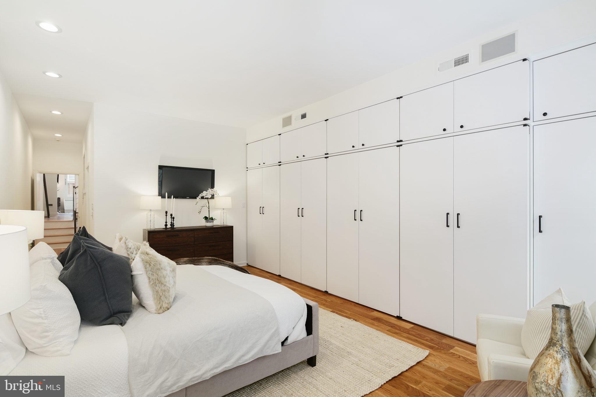 2028 Locust Street Philadelphia, PA 19103 - Photo 14 of 31 a bedroom with a bed and a flat screen tv