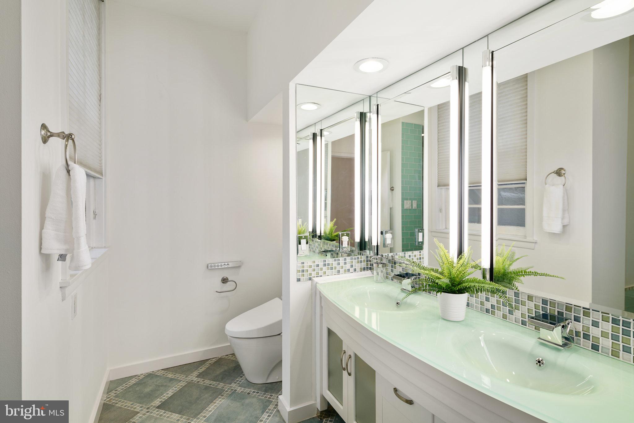 2028 Locust Street Philadelphia, PA 19103 - Photo 15 of 31 a bathroom with a granite countertop sink toilet and shower