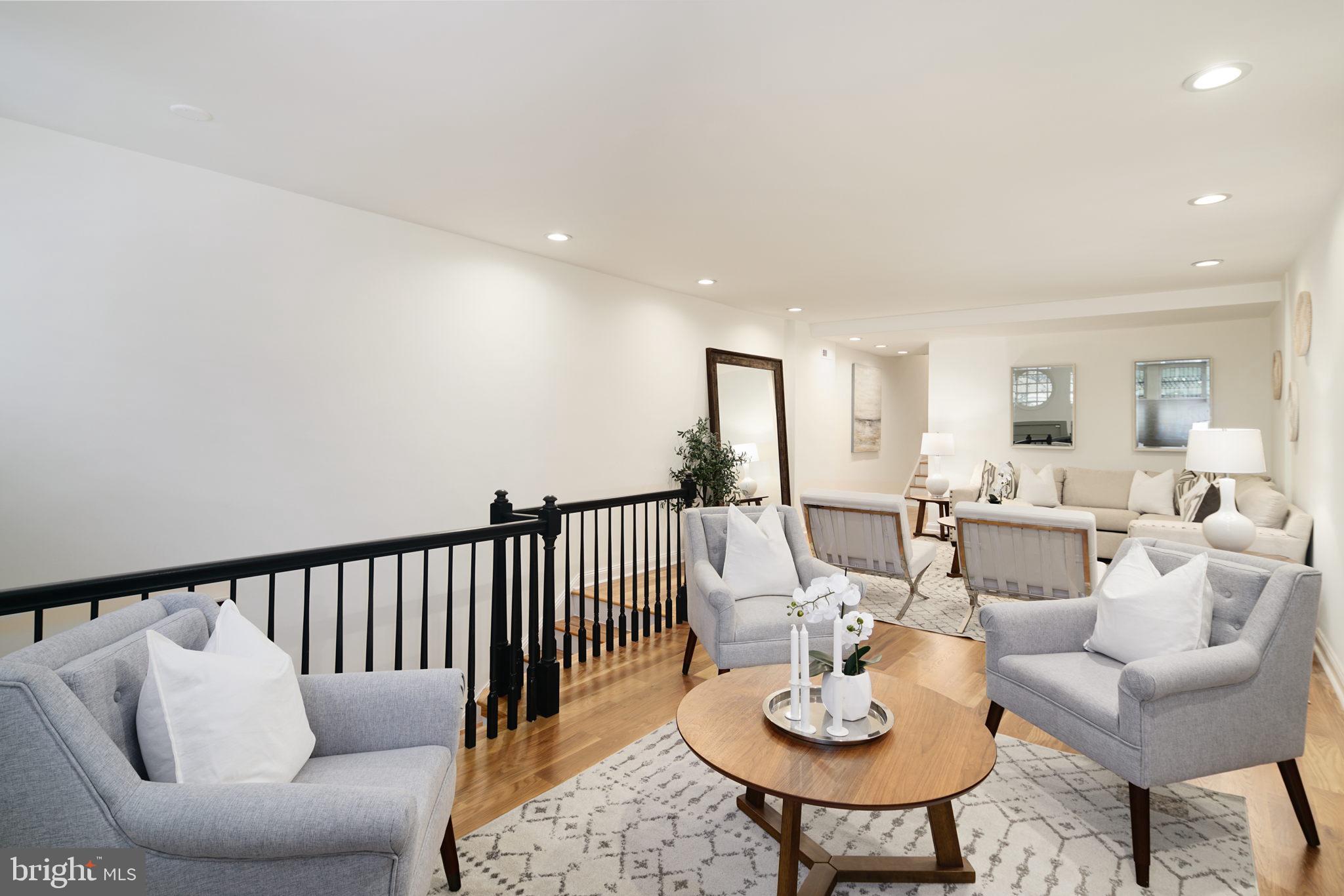 2028 Locust Street Philadelphia, PA 19103 - Photo 2 of 31 a living room with furniture and a dining table with garden view