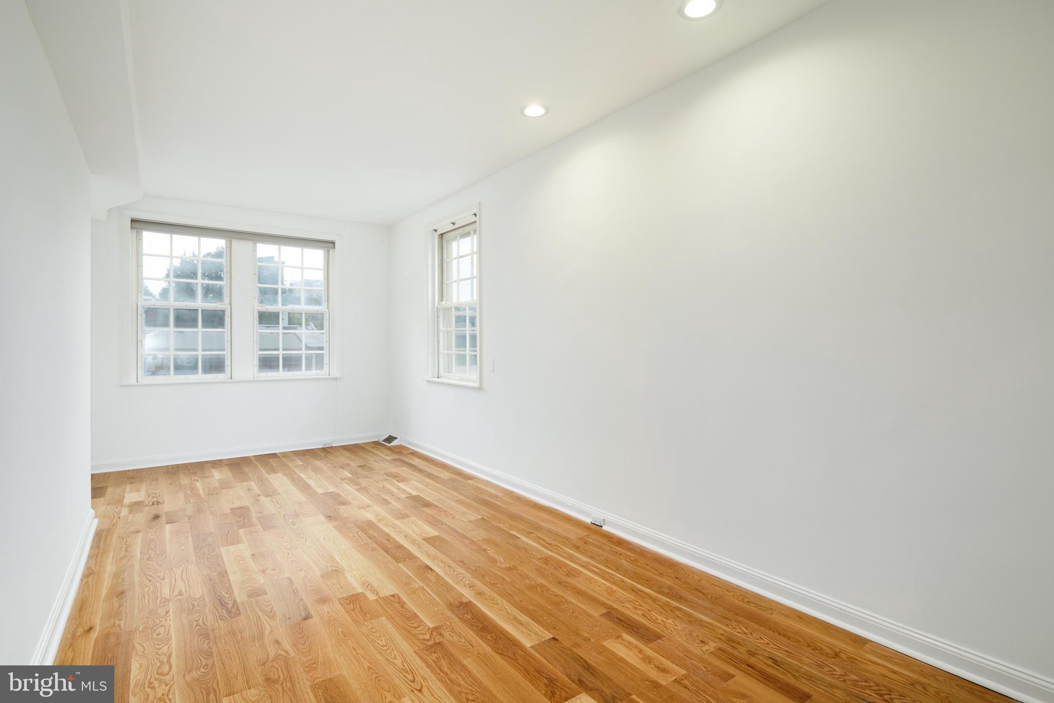2028 Locust Street Philadelphia, PA 19103 - Photo 22 of 31 a view of an empty room with wooden floor and a window