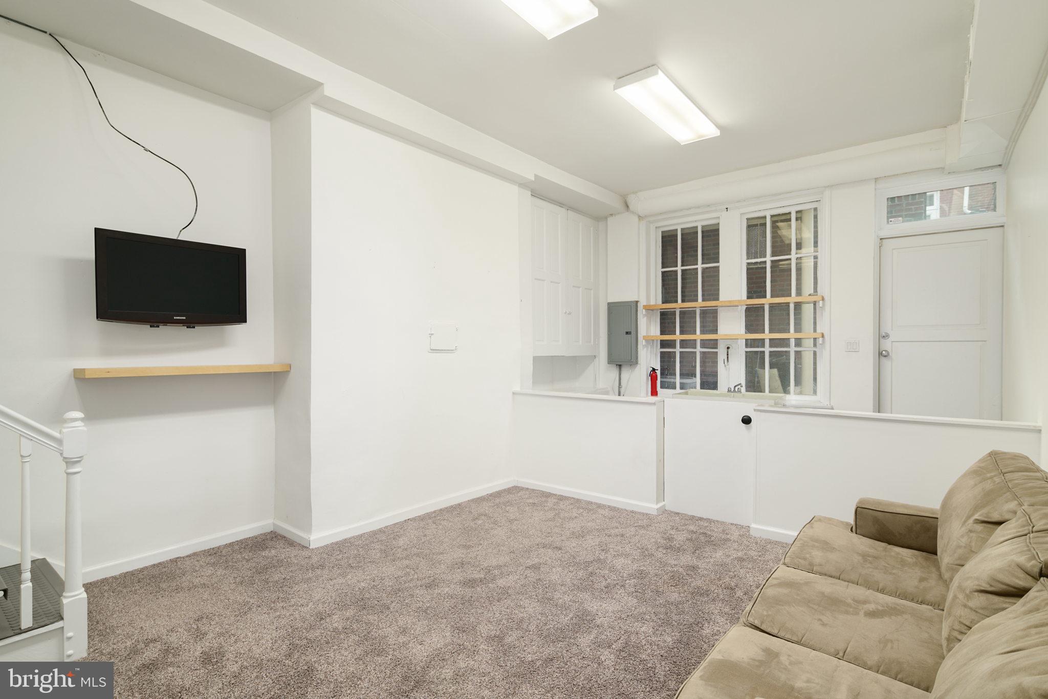 2028 Locust Street Philadelphia, PA 19103 - Photo 27 of 31 a living room with furniture and a flat screen tv