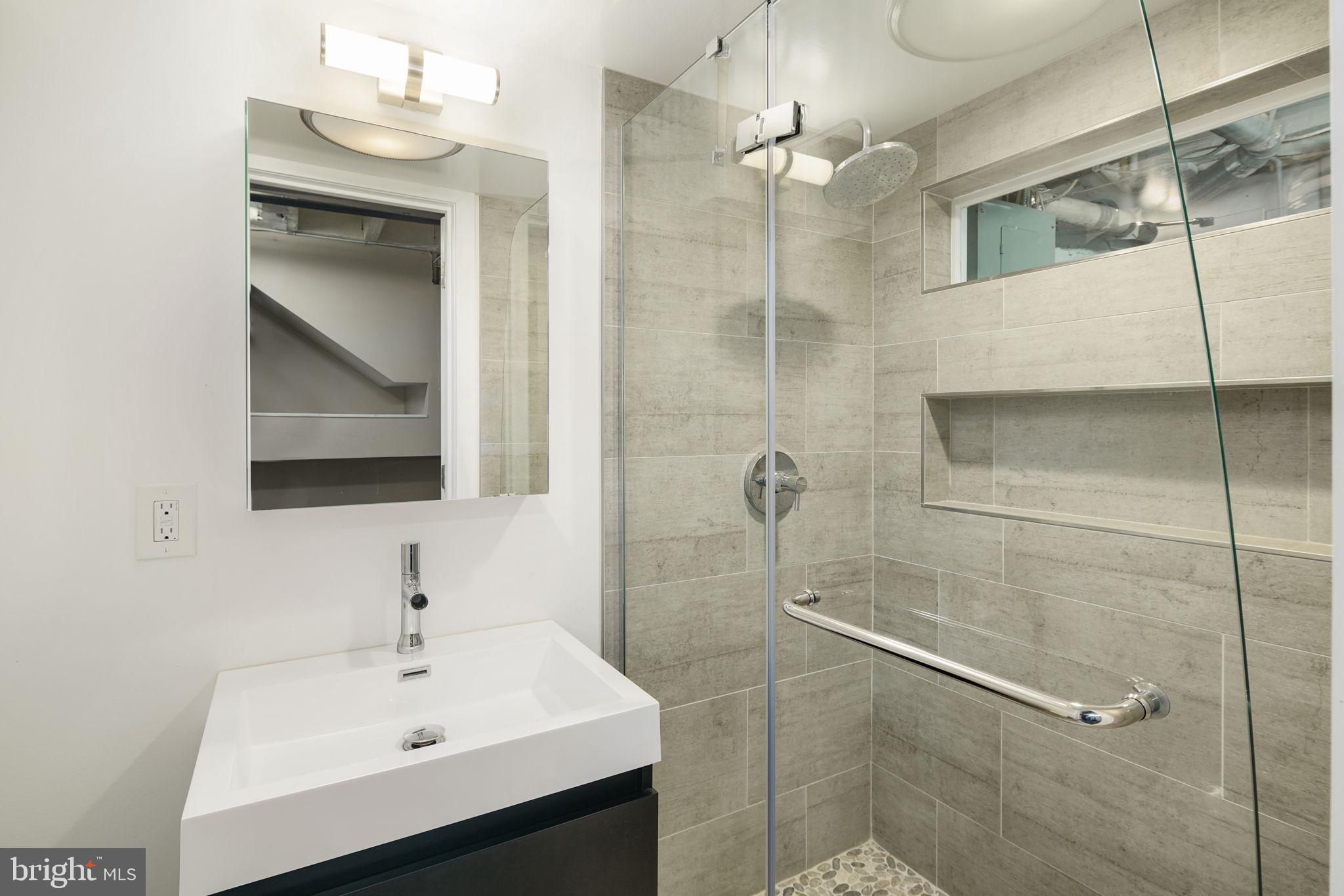 2028 Locust Street Philadelphia, PA 19103 - Photo 29 of 31 a bathroom with a sink and mirror