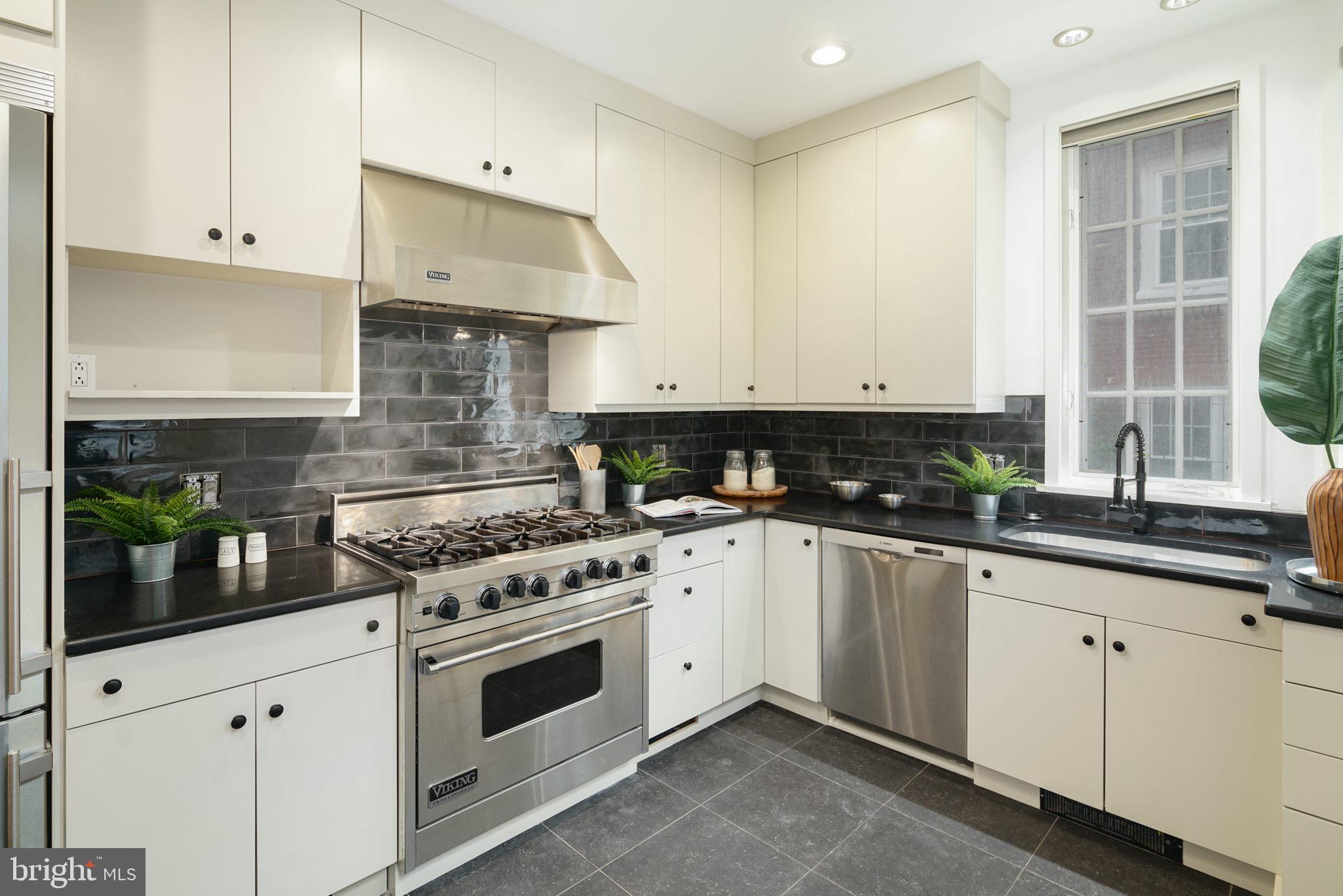 2028 Locust Street Philadelphia, PA 19103 - Photo 10 of 31 a kitchen with stainless steel appliances white cabinets and a stove a sink