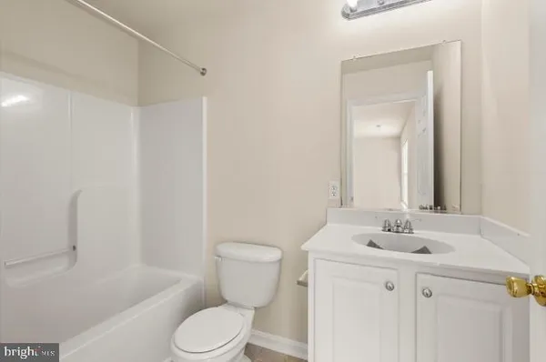 a bathroom with a sink toilet vanity and shower