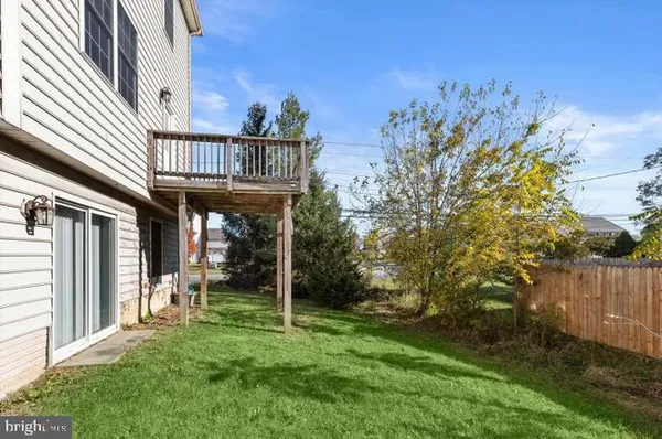 a view of a porch with furniture and a yard
