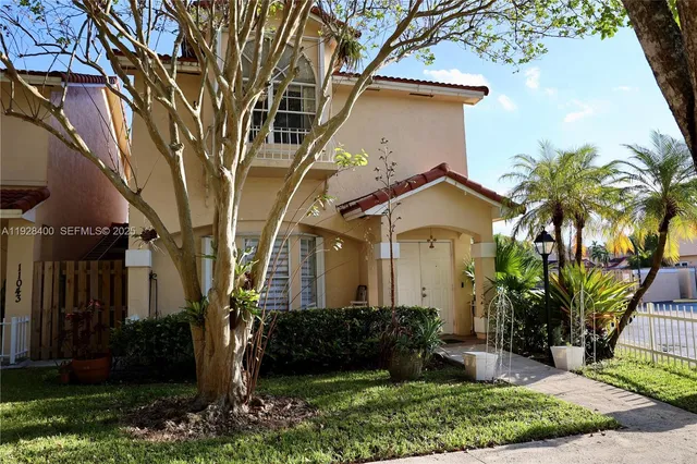 a view of a house with a flower garden
