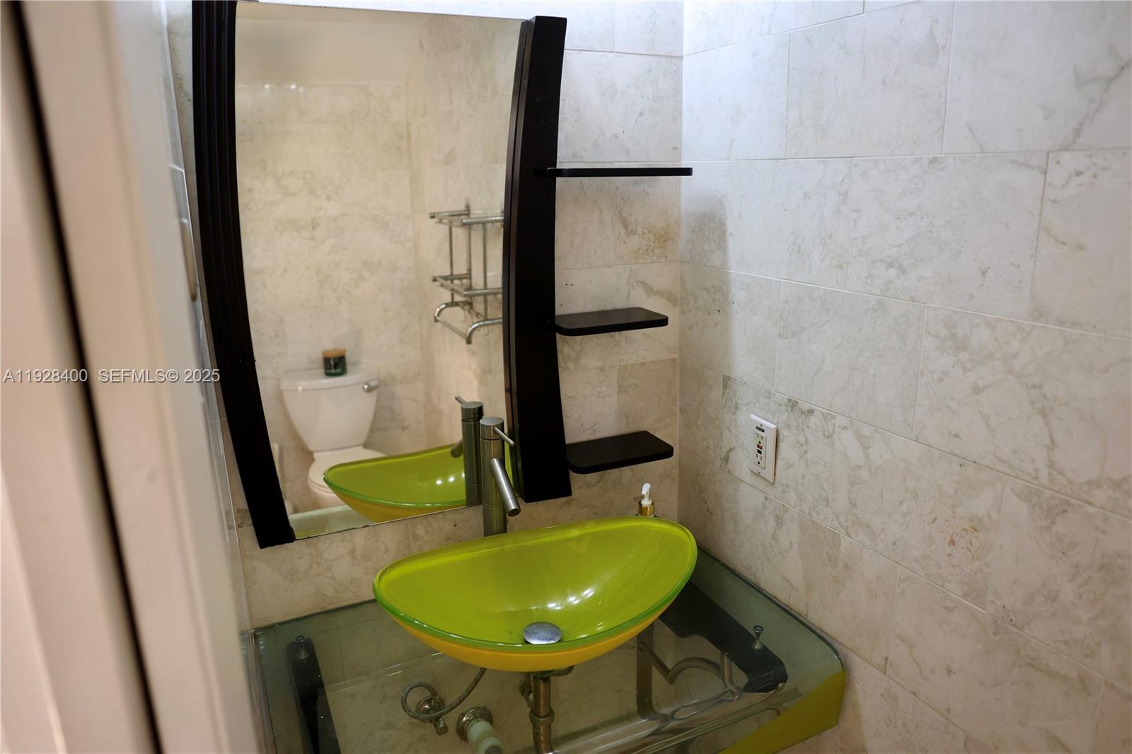 11049 Southwest 152nd Court Miami, FL 33196 - Photo 13 of 57 a bathroom with a sink and a mirror