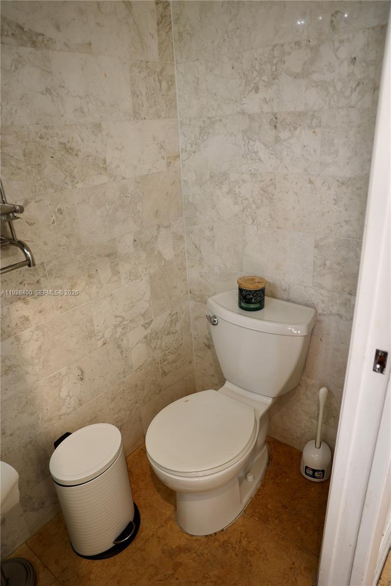 11049 Southwest 152nd Court Miami, FL 33196 - Photo 14 of 57 a white toilet sitting next to a white wall