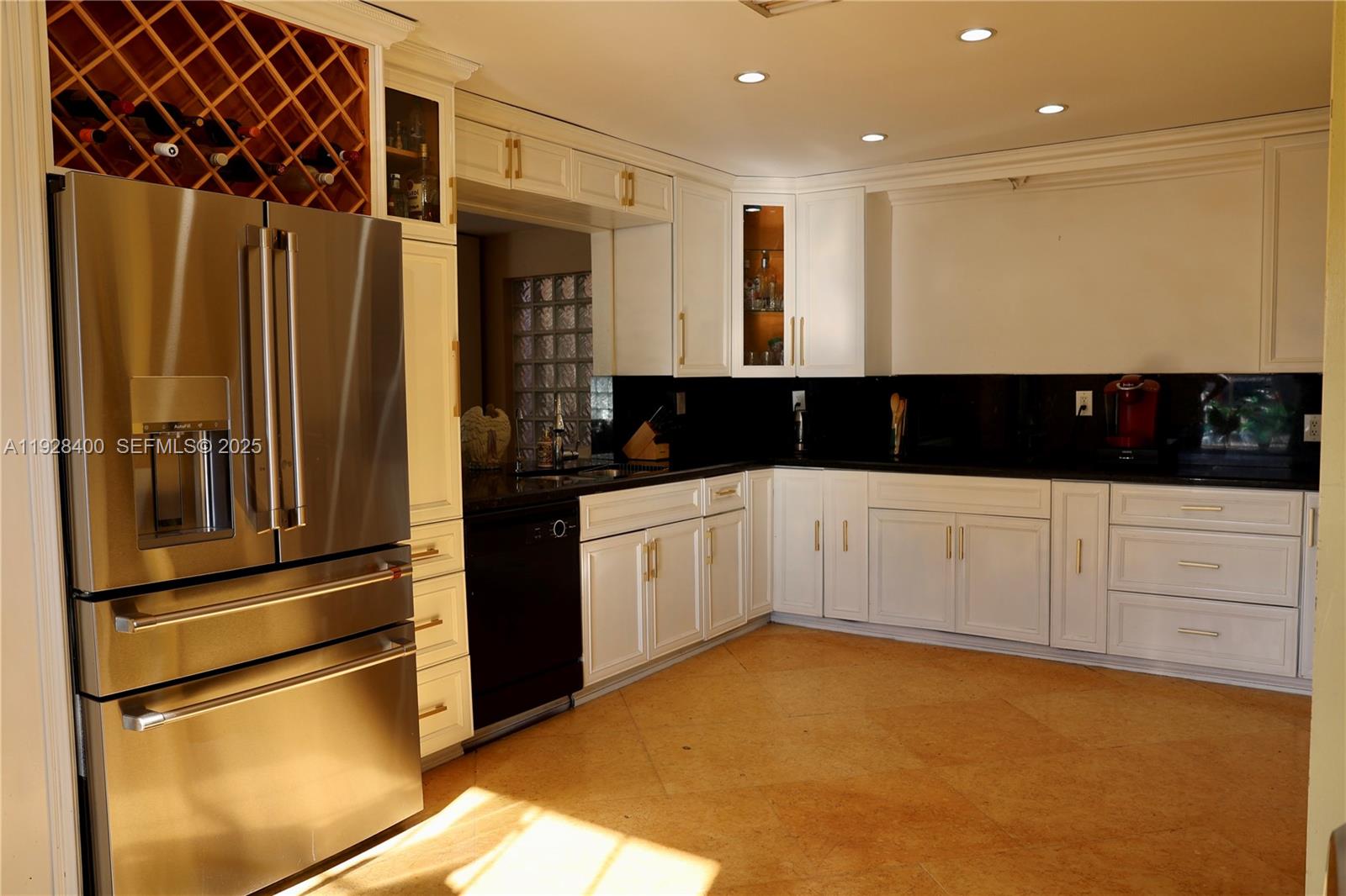 11049 Southwest 152nd Court Miami, FL 33196 - Photo 17 of 57 a kitchen with stainless steel appliances a refrigerator and white cabinets