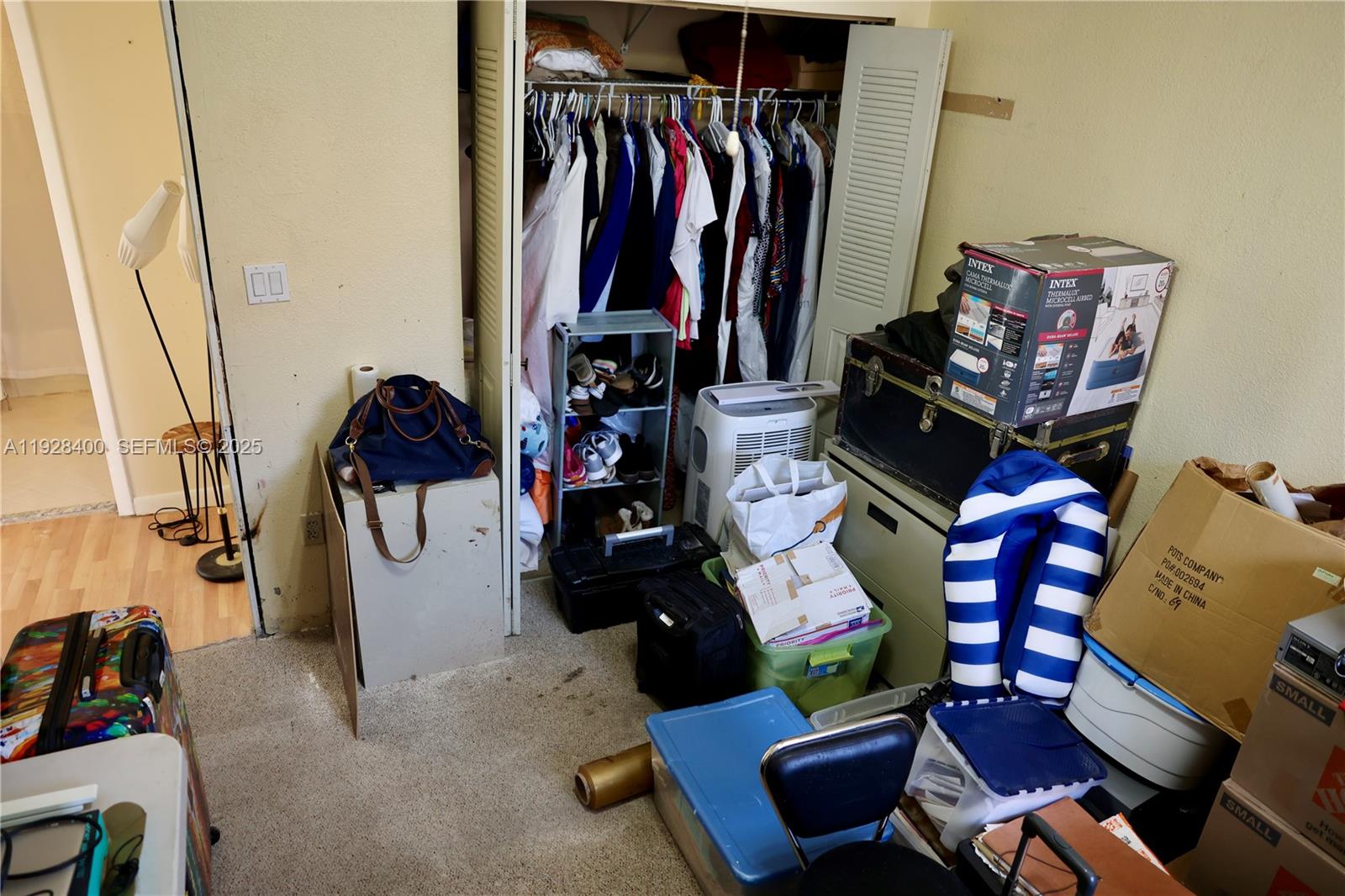 11049 Southwest 152nd Court Miami, FL 33196 - Photo 24 of 57 a view of walk in closet with clothes and shoes
