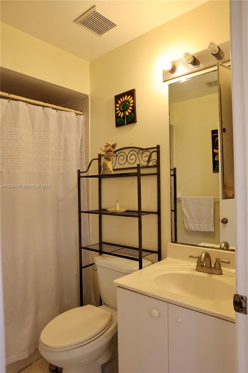 11049 Southwest 152nd Court Miami, FL 33196 - Photo 25 of 57 a bathroom with a sink a toilet and shower