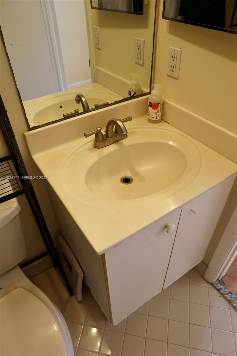 11049 Southwest 152nd Court Miami, FL 33196 - Photo 27 of 57 a bathroom with a sink and a mirror