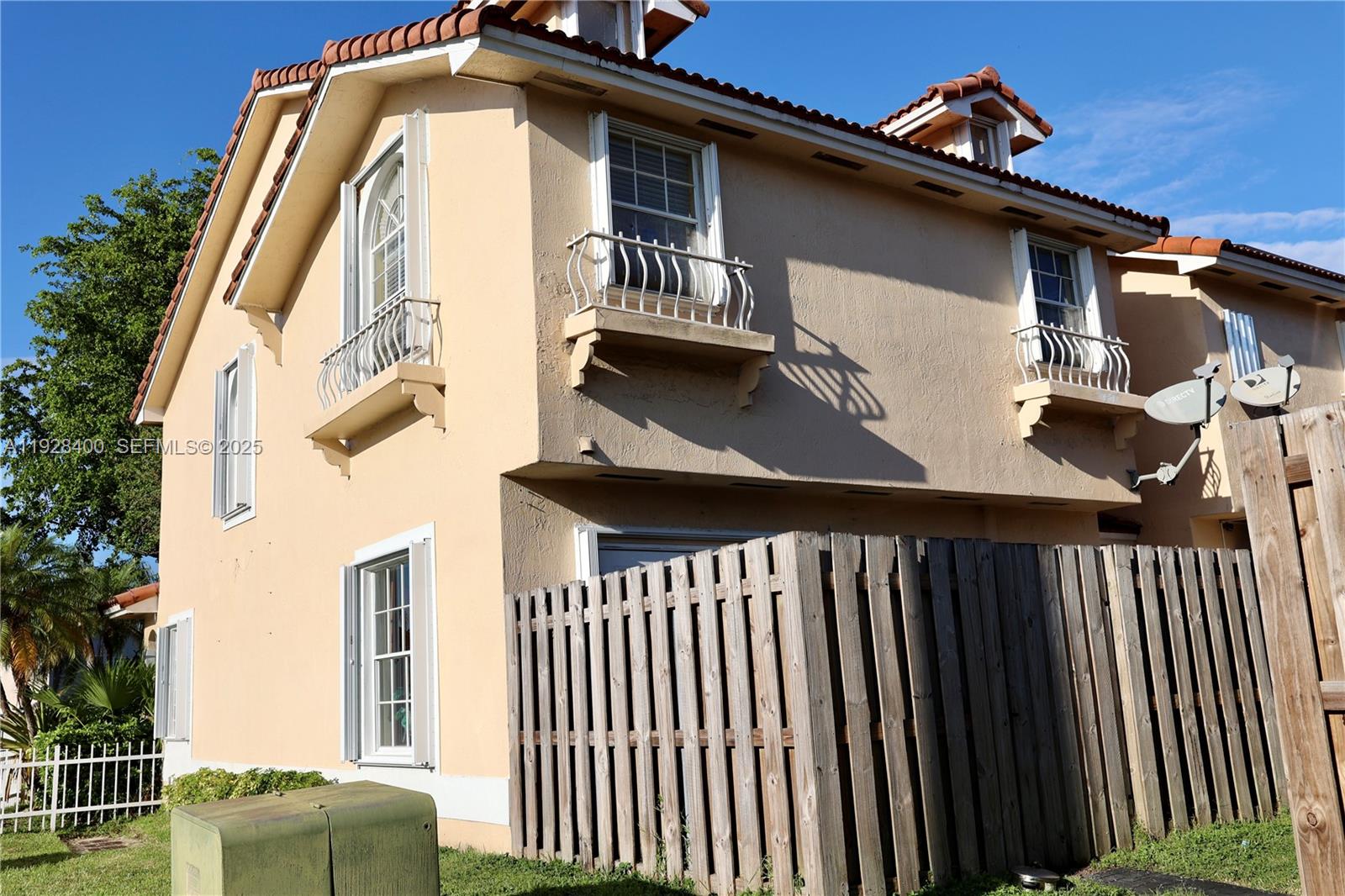 11049 Southwest 152nd Court Miami, FL 33196 - Photo 3 of 57 a view of a house with wooden fence