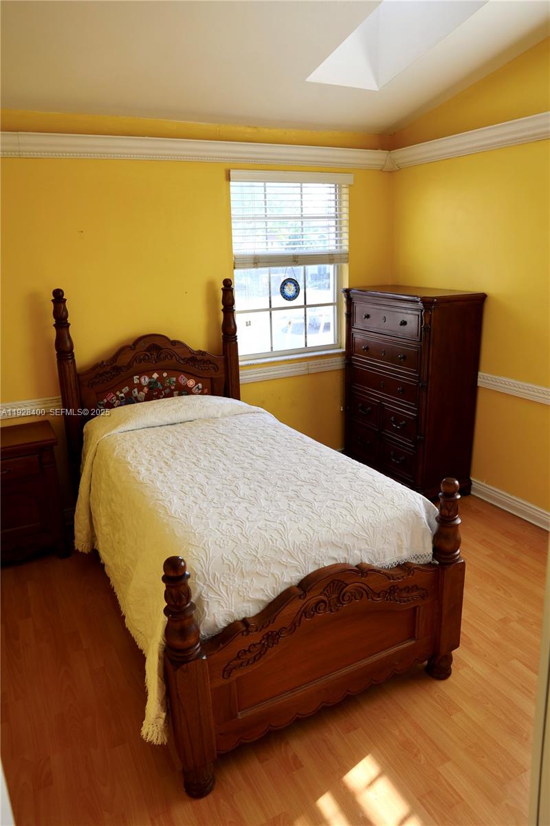 11049 Southwest 152nd Court Miami, FL 33196 - Photo 31 of 57 a bed sitting in a bedroom with a tv