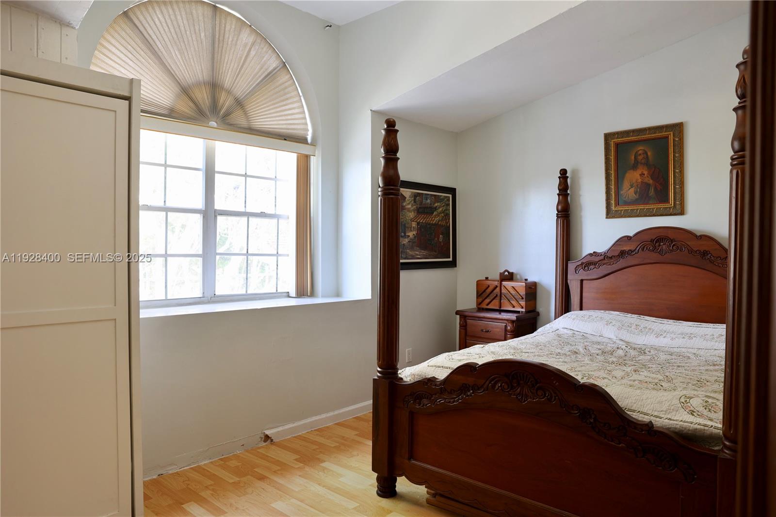 11049 Southwest 152nd Court Miami, FL 33196 - Photo 36 of 57 a bedroom with a bed and wooden floor