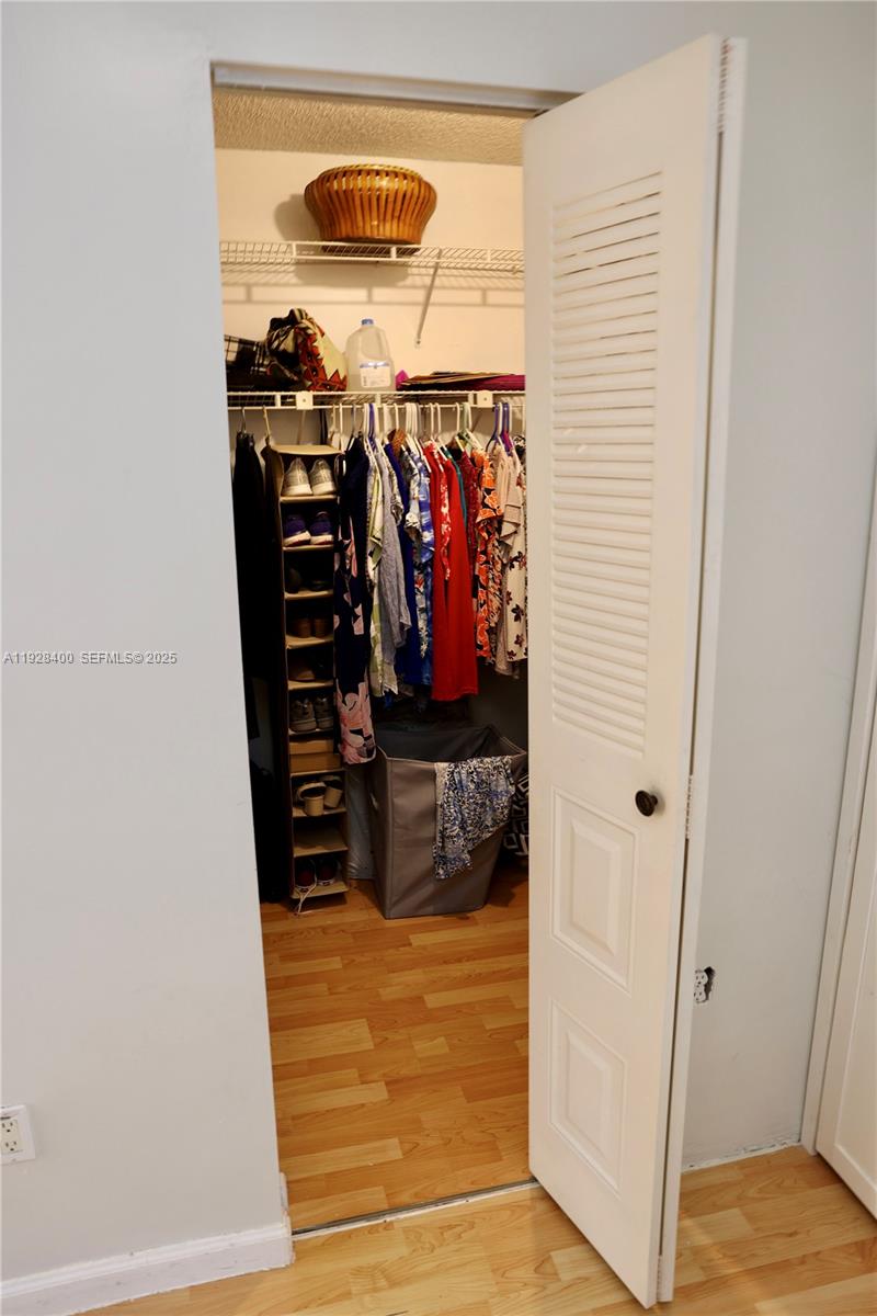 11049 Southwest 152nd Court Miami, FL 33196 - Photo 39 of 57 a view of walk in closet with clothes and shoes