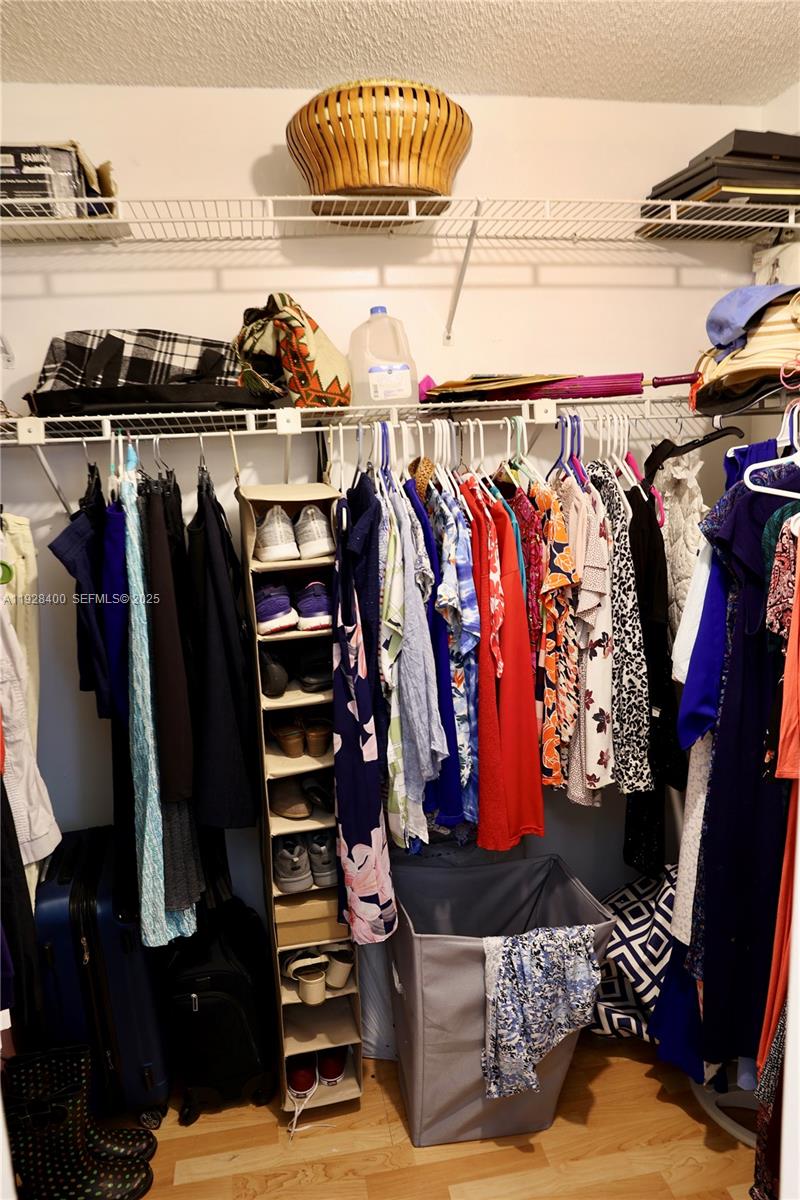 11049 Southwest 152nd Court Miami, FL 33196 - Photo 40 of 57 a view of walk in closet with clothes and shoes