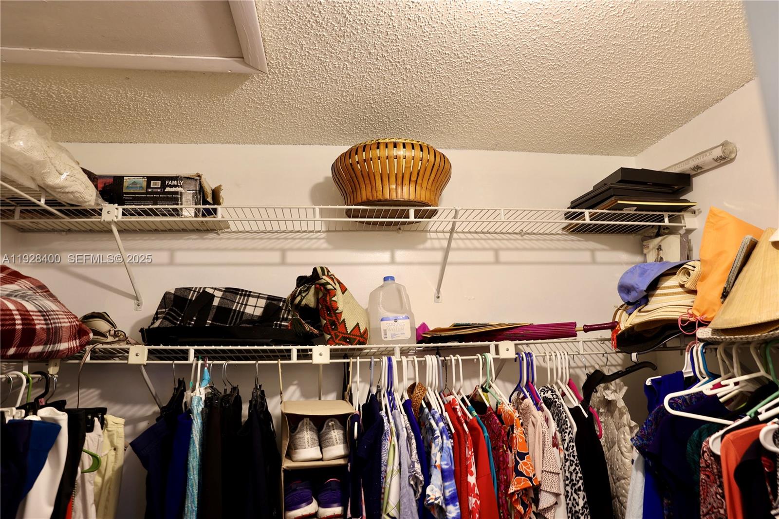 11049 Southwest 152nd Court Miami, FL 33196 - Photo 41 of 57 a view of walk in closet with clothes and shoes